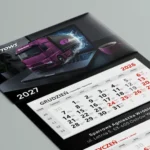Kalendarz trójdzielny z wypukłą główką dla spedycji Sparrows na 2027 rok, fioletowa ciężarówka wyjeżdżająca z ekranu laptopa